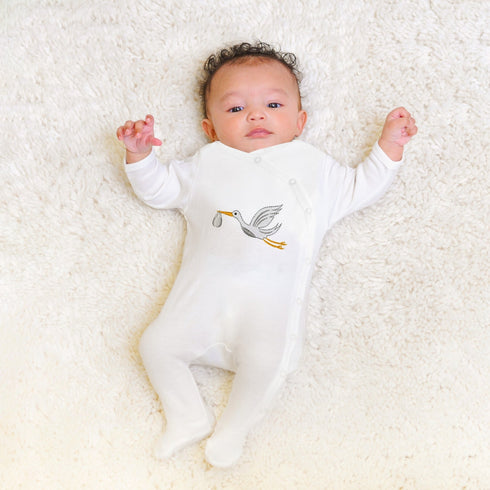 Side-snap onesie with stork embroidery, made from soft Prima Cotton