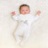 Side-snap onesie with stork embroidery, made from soft Prima Cotton