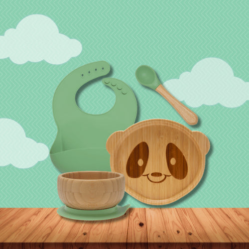 Eco-friendly bamboo baby feeding set with suction bowl, panda-shaped plate, silicone bib, and spoon for toddlers and infants.