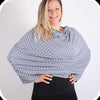 Woman wearing Mama Bamboo grey polka dot multi-use nursing cover, available at Calm Nest for stylish feeding privacy.