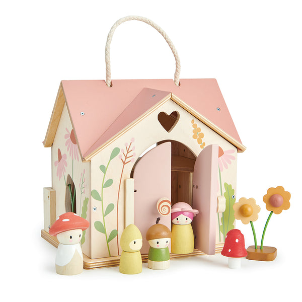 Tender Leaf Rosewood Cottage wooden play set with hinged doors, floral‑printed roof, swing, stove, lamp, stools & toadstool.