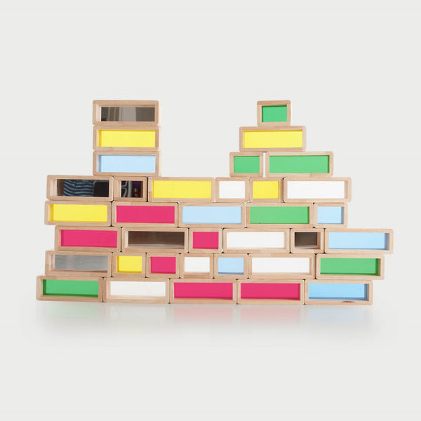Rainbow Bricks – PK36: large and small rubberwood building bricks with transparent coloured acrylic inserts (red, green, blue, yellow, clear, mirror) for stacking, colour‑mixing and light-box sensory play